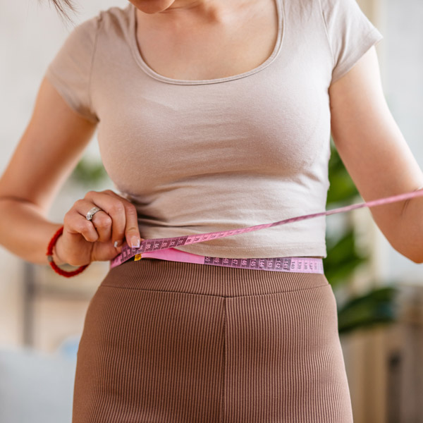 woman measuring waist